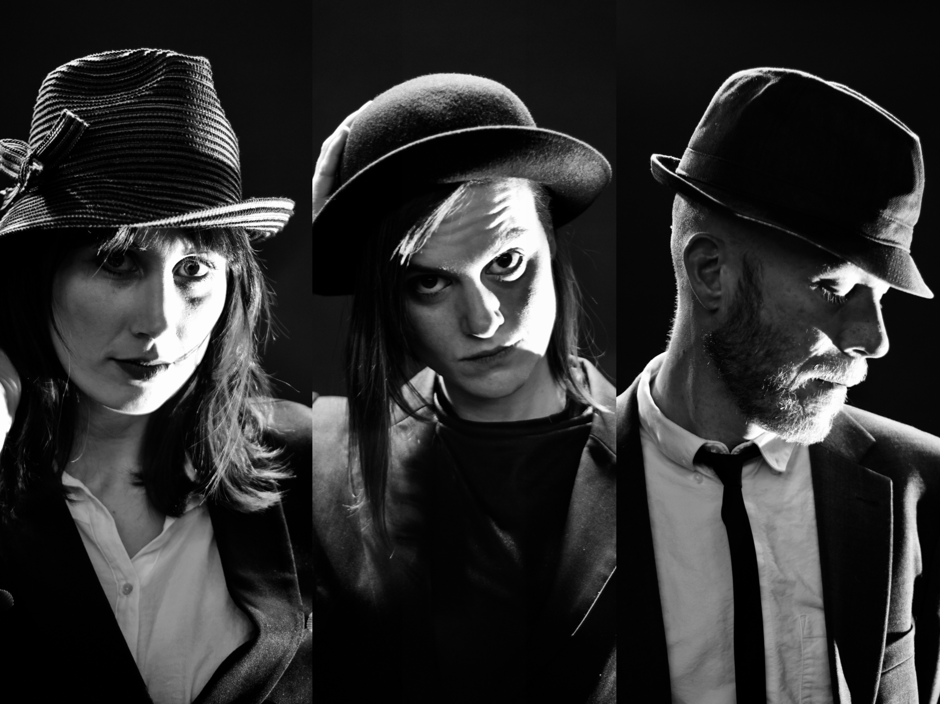 En svartvit bild med musikerna i kostymer och hatt.
