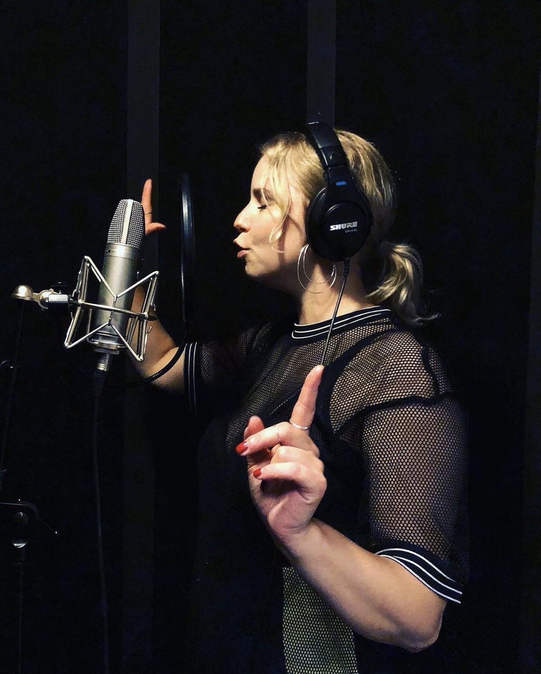 En bild på sångläraren Catharina som sjunger i en studio